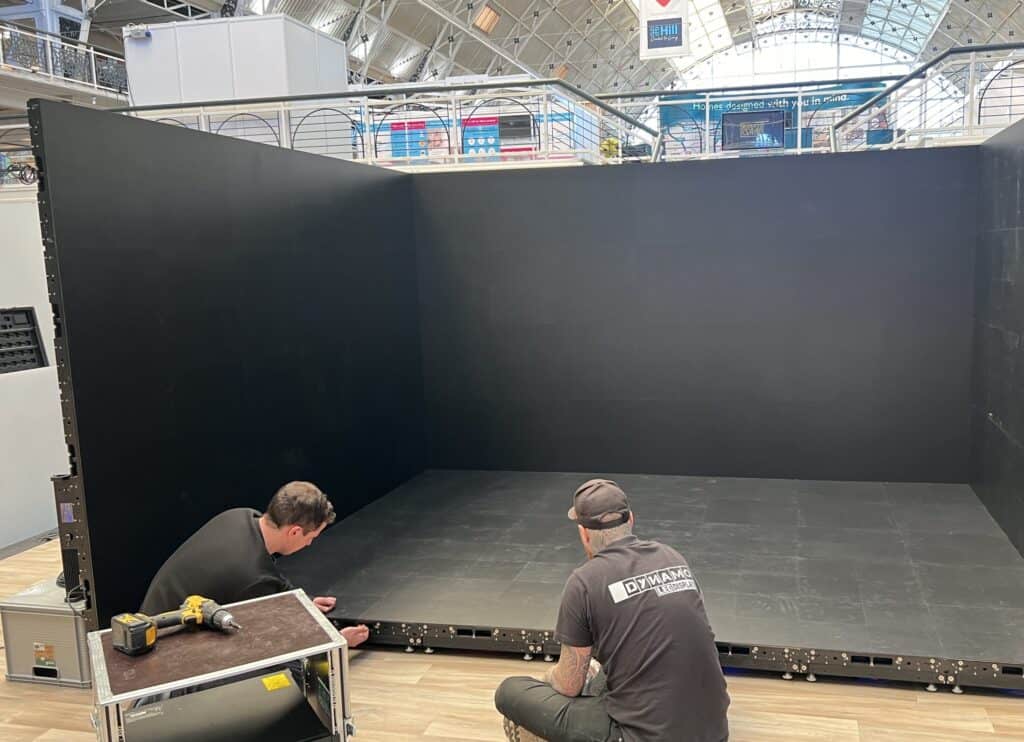 AV crew installing modular LED walls during an exhibition access window