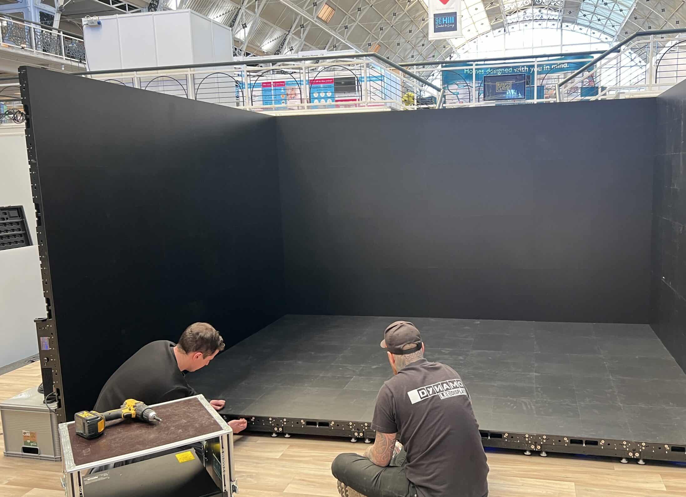 Budget Realities: Where the Money Goes โ bespoke led lead time โ av crew installing modular led walls during an exhibition