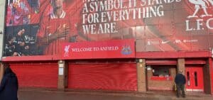 Liverpool FC stadium ticket‑office outdoor LED display showing match information.