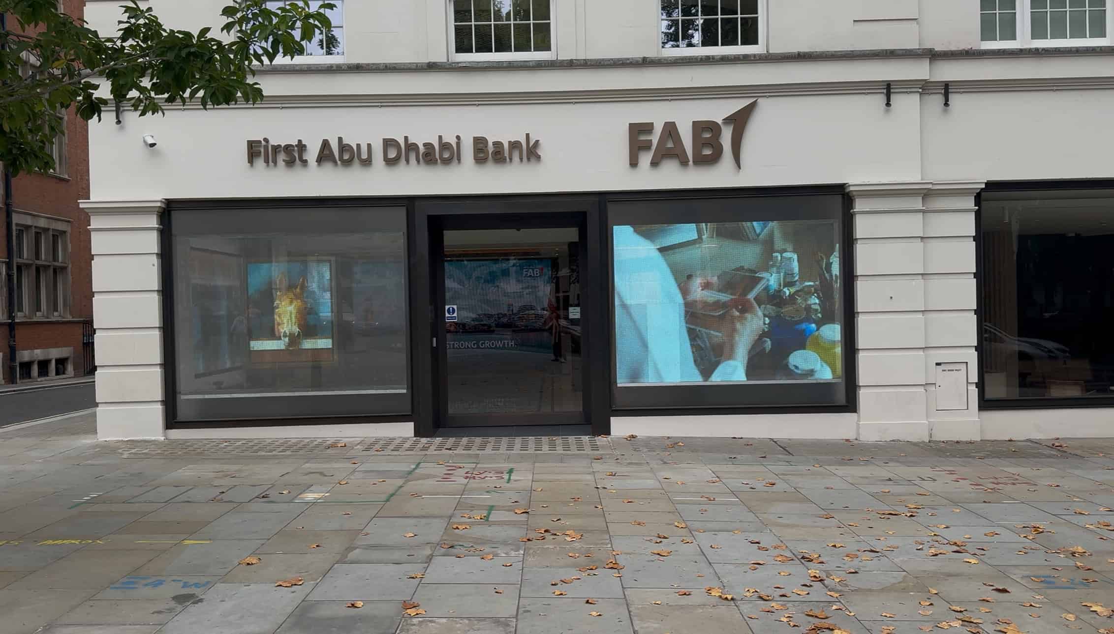 Transparent LED shopfront display showing high transparency with bright digital content visible in daylight