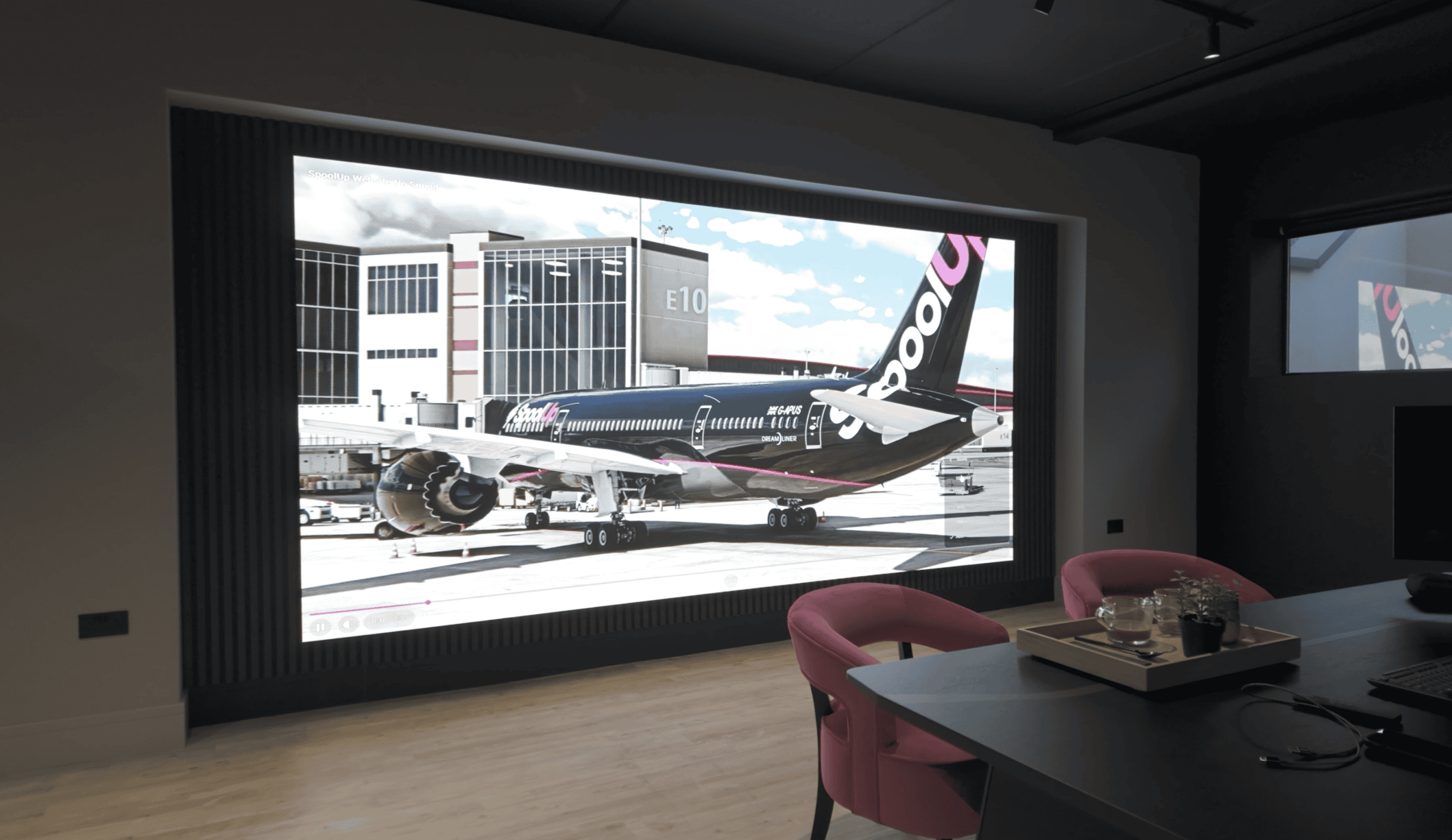 Wall-mounted LED video wall in a Winchester office meeting room, displaying a seamless high-resolution image with no joins between panels