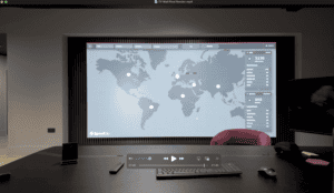 Wall‑mounted office LED video wall in a modern showroom meeting space