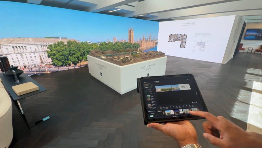Sales agent controlling LED scenes via iPad and NovaStar CMS Westminster Tower marketing suite