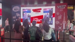 Crowd watching the two-player K-pop dance challenge scored live on Dynamo's rental LED wall at the BTS The City Arirang London activation, Outernet London