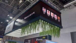 U-shaped hanging LED banner rigged to truss over the Biotech stand at ESCRS 2026, ExCeL London, showing the Meet the Masters line-up