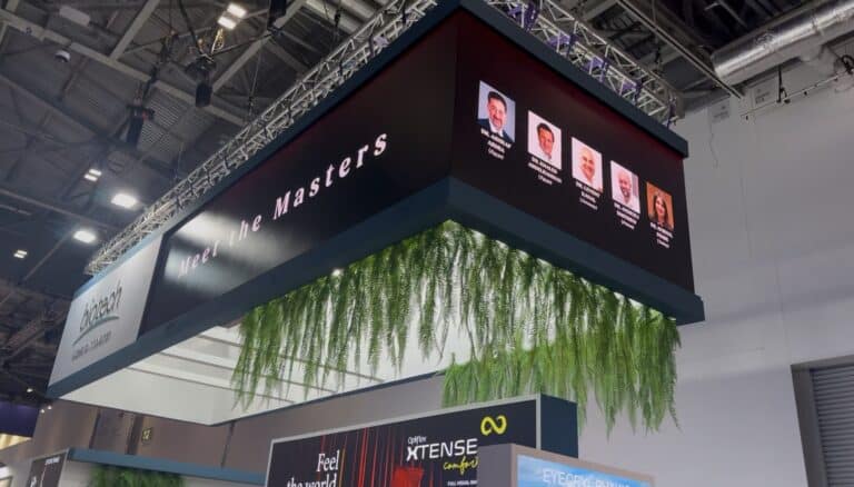 U-shaped hanging LED banner rigged to truss over the Biotech stand at ESCRS 2026, ExCeL London, showing the Meet the Masters line-up