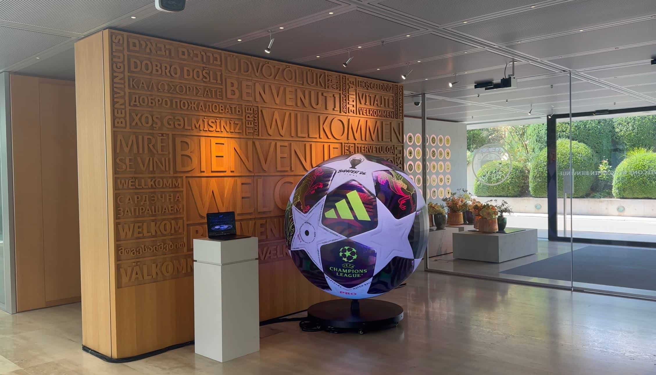 Wide view of the UEFA lobby with the LED sphere on its castored trolley base in front of the welcome wall