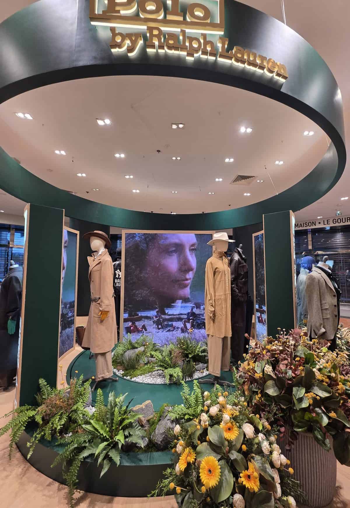 Low angle of the Polo by Ralph Lauren podium header ring and the central LED screen showing the autumn campaign film, Galeries Lafayette