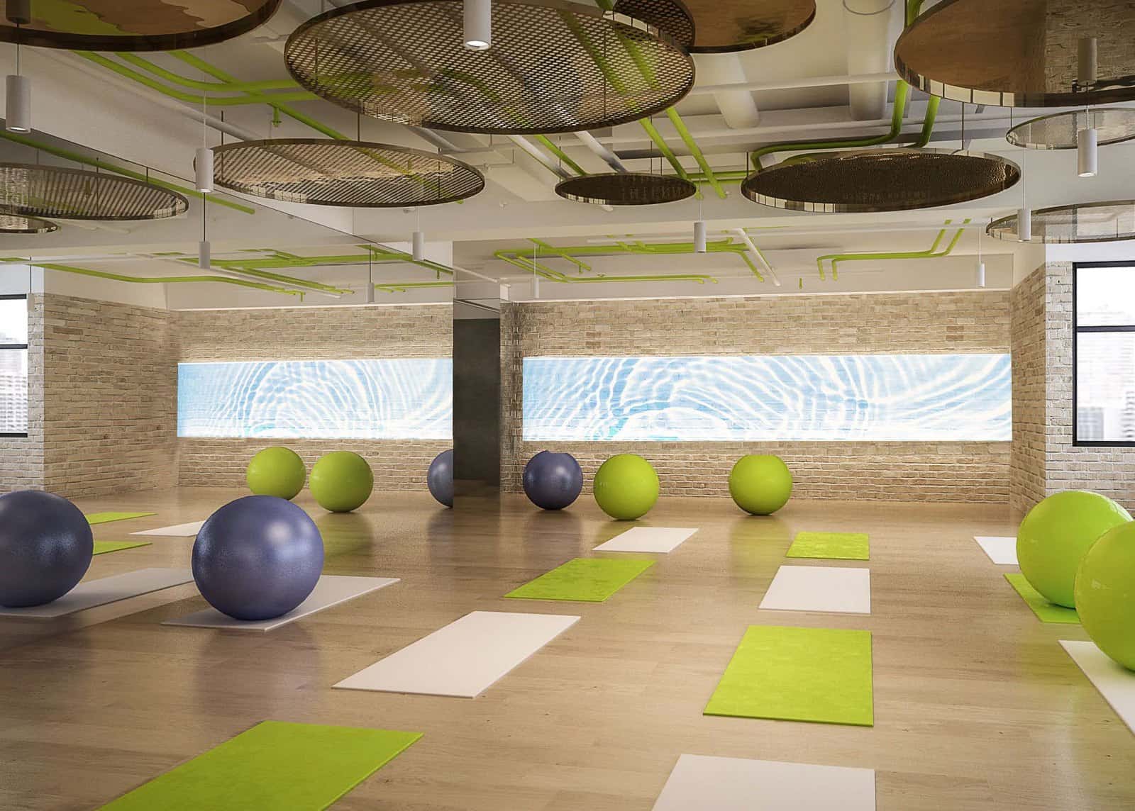 DSK Series hidden LED screens in a stone-finish wall of a fitness studio